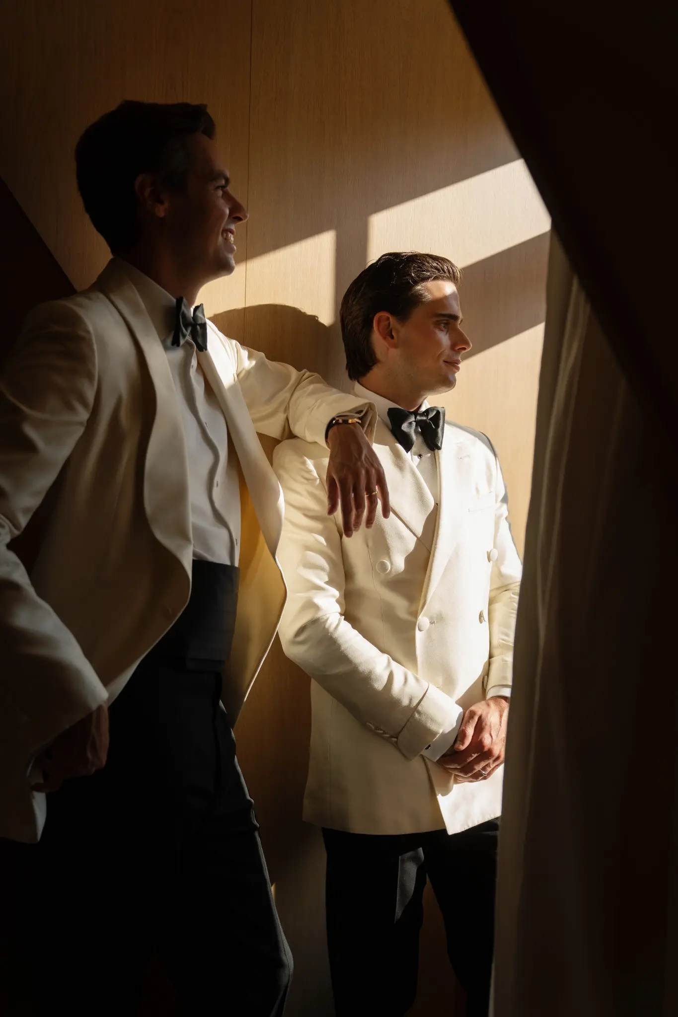Peter and Parker in sculptural window light on their wedding day