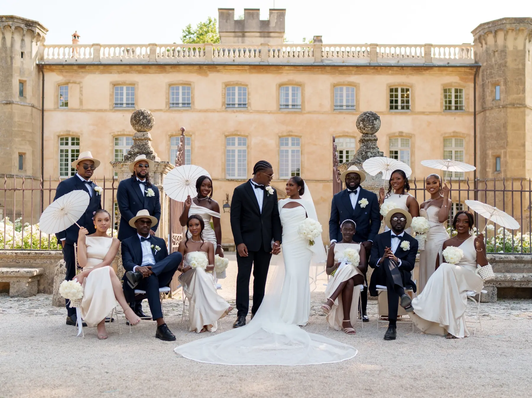 Kenne and Ugo with their wedding party at a French château