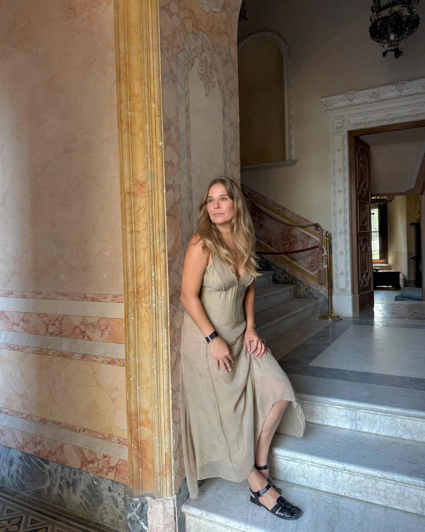 Marina Muravnik in a softly lit historic interior