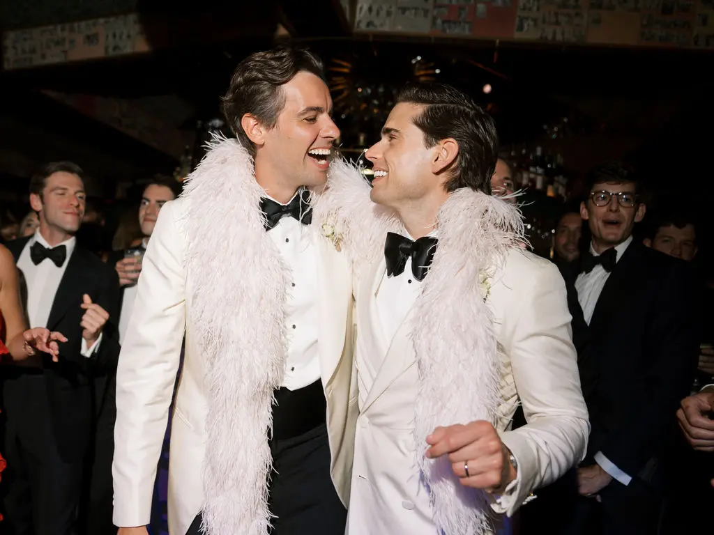 Peter and Parker laughing together during their wedding celebration